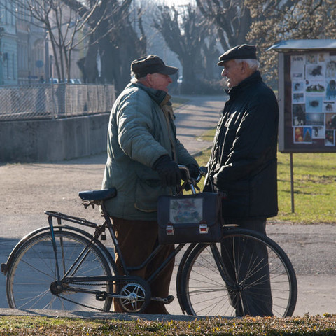 Two elderly men in the street