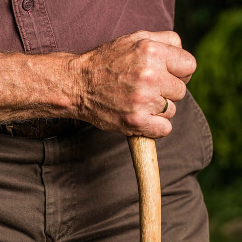 Elderly man holding a walking stick