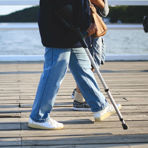 Elderly man using a walking aid