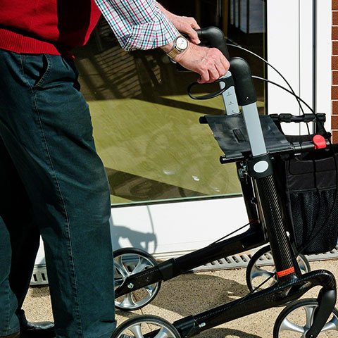 Elderly man using a walker