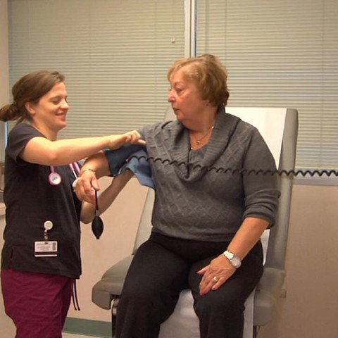 Elderly lady having her blood pressure taken