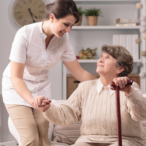 Carer helping elderly lady