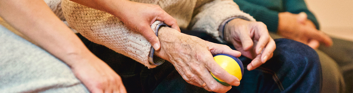 Elderly lady holding a ball