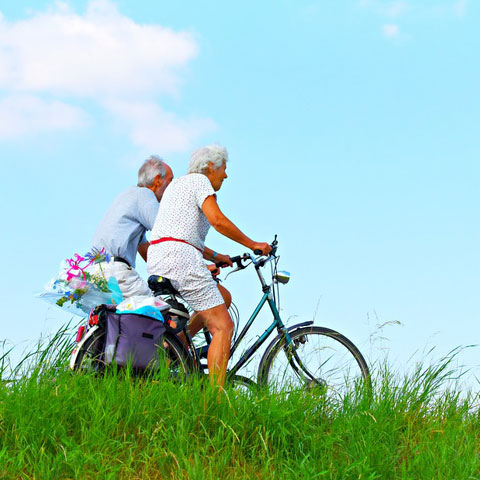 Elderly couple riding bikes