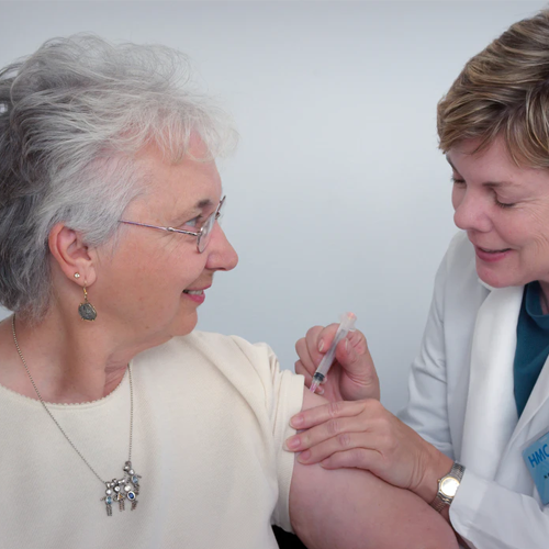elderly woman having vaccine