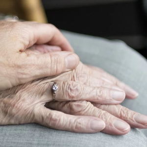 Elderly couple holding hands